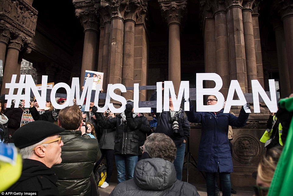 'No Muslim ban': People are pictured gathering at Boston's Copley Square Sunday to protest against the immigration bans