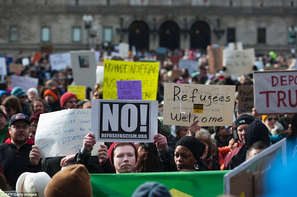A sea of protesters took to Copley Square on Sunday, holding signs reading messages such as: 'Refugees welcome'