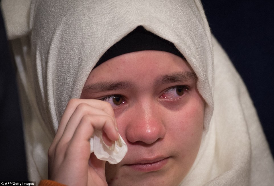 Maya Kurahakish, a Syrian refugee, wiped aways tears as Senator Schumer, D-NY, spoke during Sunday's press conference