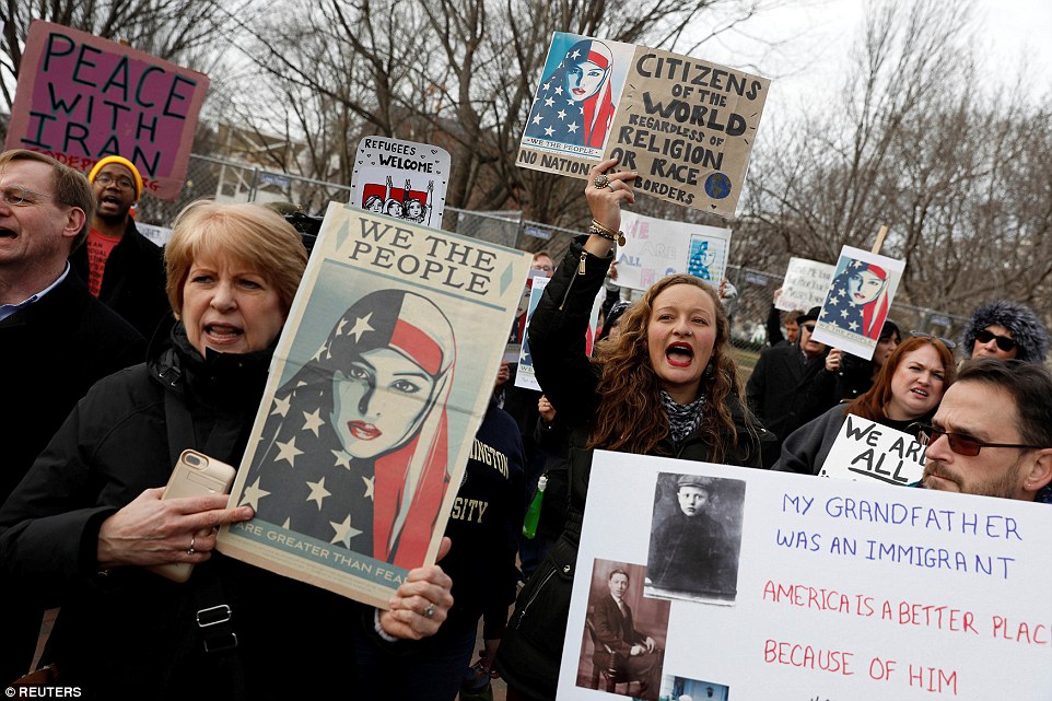 One of the demonstrators outside the White House held a sign dedicated to his immigrant grandfather, saying America was 'a better place because of him'