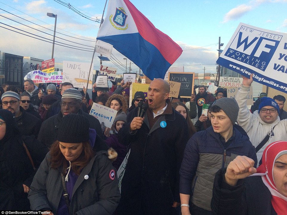 Senator Cory Booker (center) was also seen marching with the protesters at Elizabeth Detention Center in New Jersey