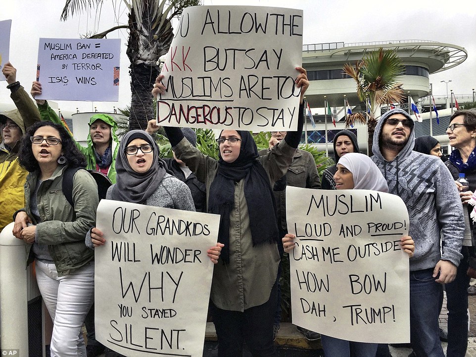 Another group of protesters is seen outside Miami International Airport on Sunday. There have been protests across the country against Trump's immigration policy