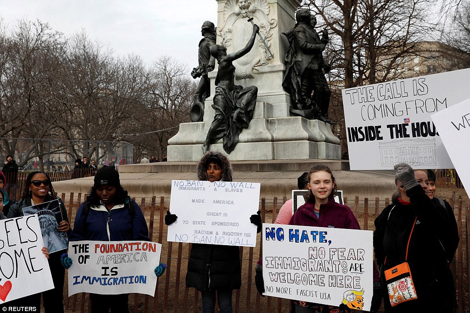 People are seen outside the White House in Washington on Sunday amid ongoing protests against president Trump and his immigration policy