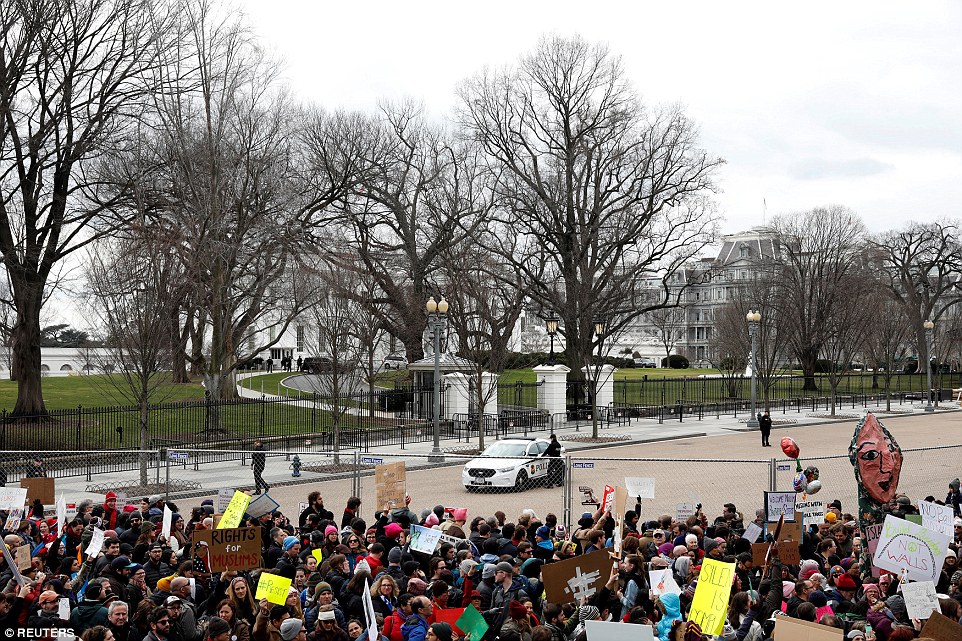 Activists gather outside the White House to protest President Donald Trump's executive actions on immigration on Sunday