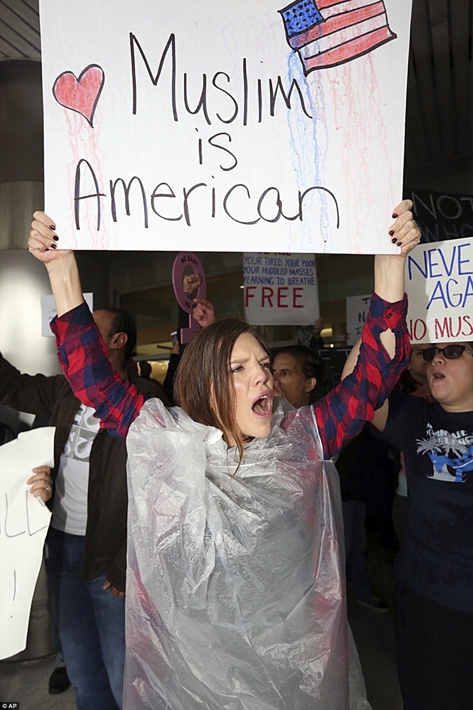 Tristan Houghton protests against President Trump's refugee ban at Miami International Airport on Sunday