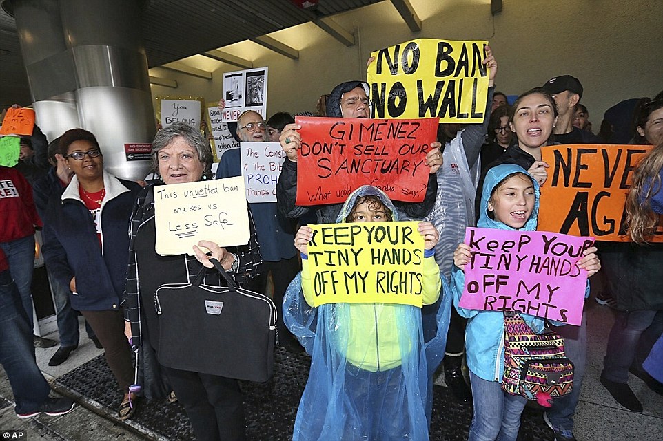 Protesters rally against President Trump's Muslim immigration policy and refugee ban on Sunday at Miami International Airport