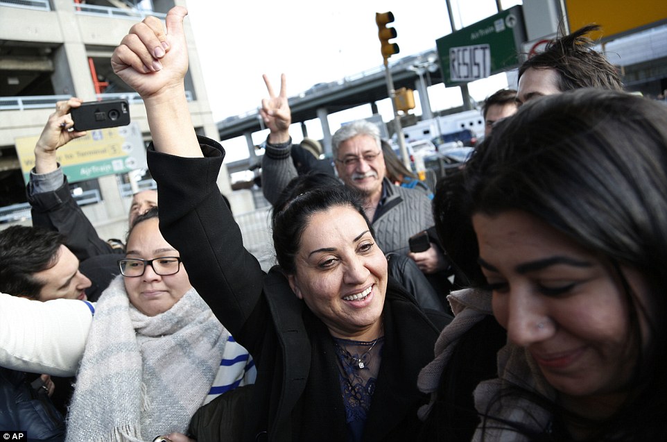 Iman Alknfushe gave a thumbs up to protesters and media as she exited John F Kennedy International airport Sunday