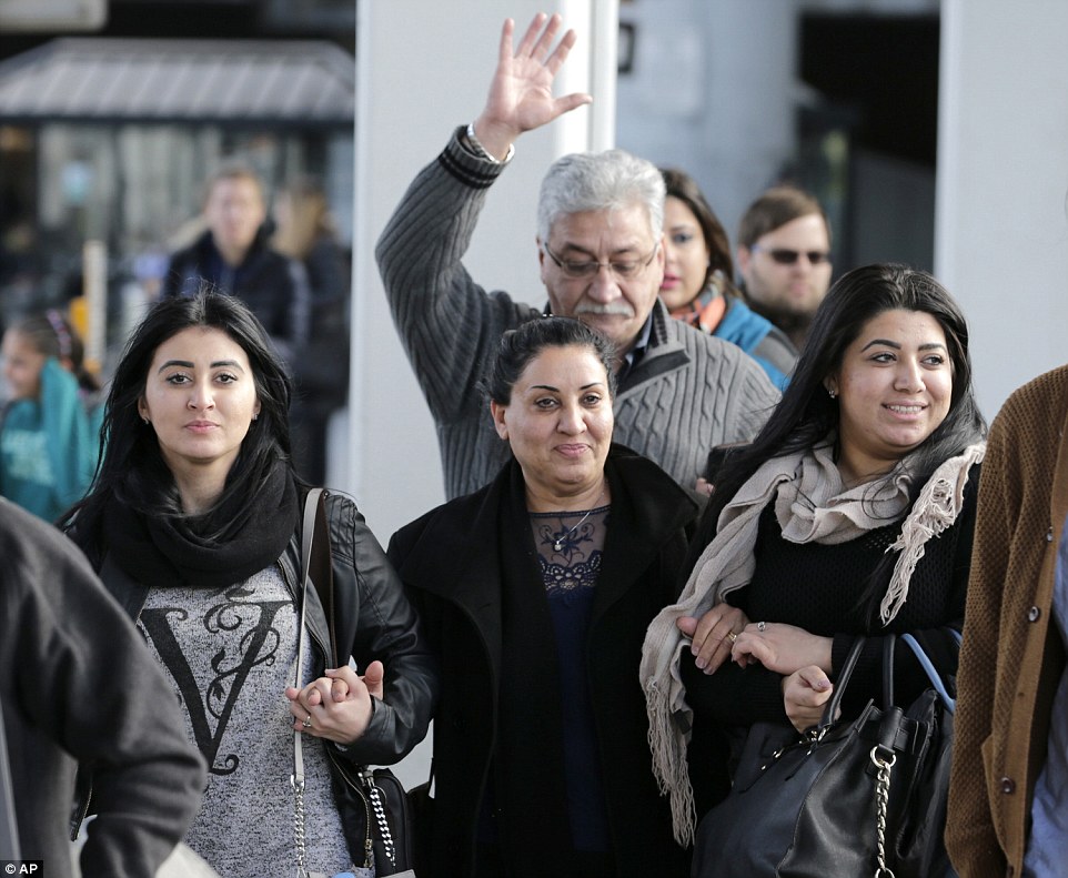 Alknfushe (center) is pictured getting out of JFK with her daughters Elaf (right) and Anfal Hussain (left) Sunday. Attorneys advocating on her behalf said Alknfushe was coming from Iraq and had been detained at the airport for more than 30 hours