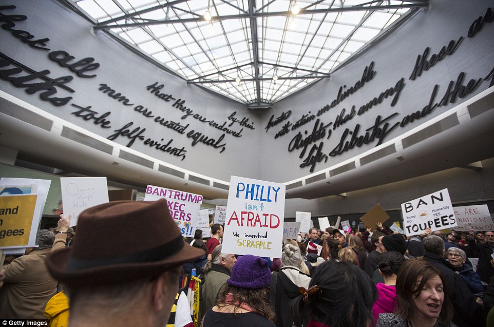 'Life, Liberty, and the Pursuit of Happiness': Demonstrators at Philadelphia International Airport gathered under walls bearing an excerpt from the Constitution