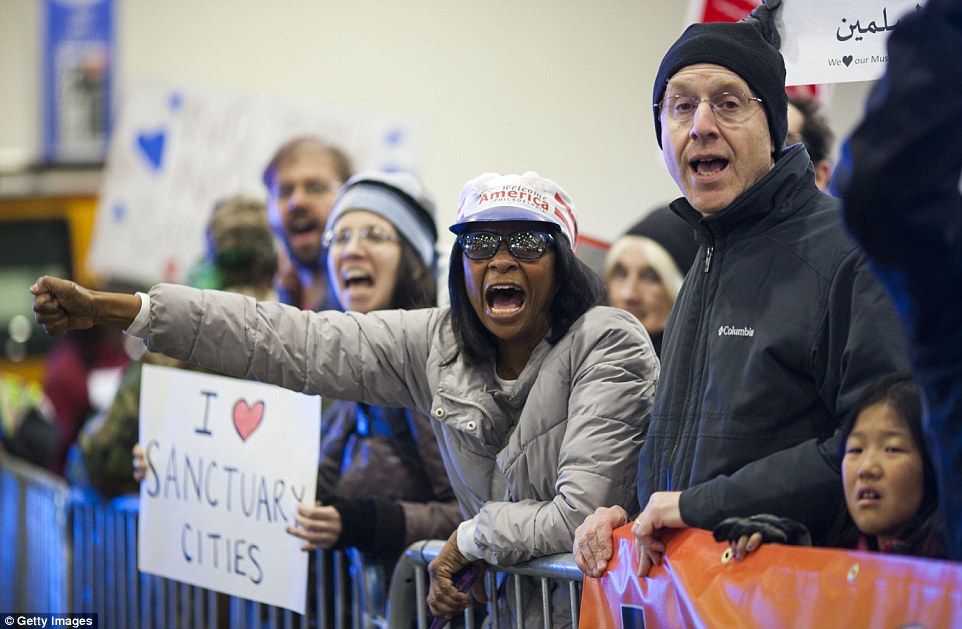 'I [heart] sanctuary cities': A protester paid tribute to cities who protect undocumented immigrants during a rally at Philadelphia International Airport