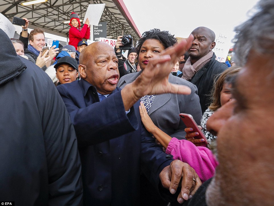 US Democratic Congressman from Georgia John Lewis (center) was greeted by people during a protest at Hartsfield-Jackson Atlanta International Airport