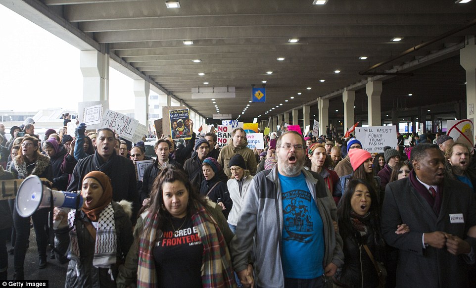 A crowd of demonstrators were seen marching at Philadelphia International Airport as part of Sunday's massive protests
