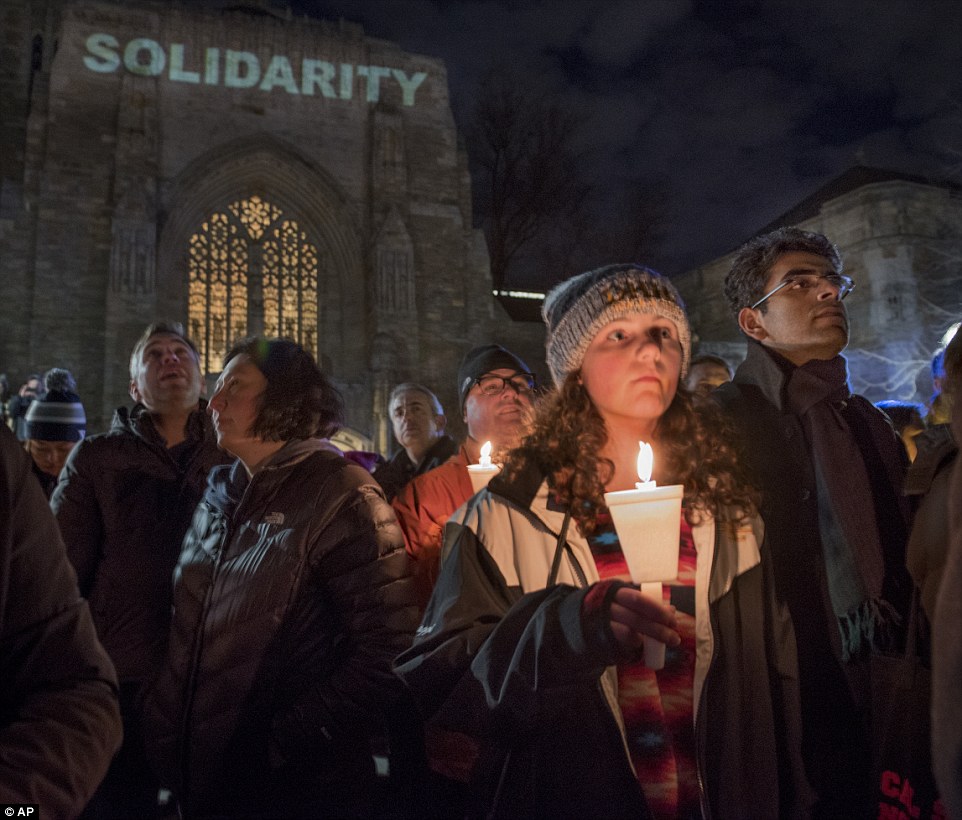 Anna Yaggi, a 15-year-old high school student from Madison, held a candle in front of Sterling Memorial Library at Yale University in New Haven. Hundreds turned out for the vigil in support of refugees