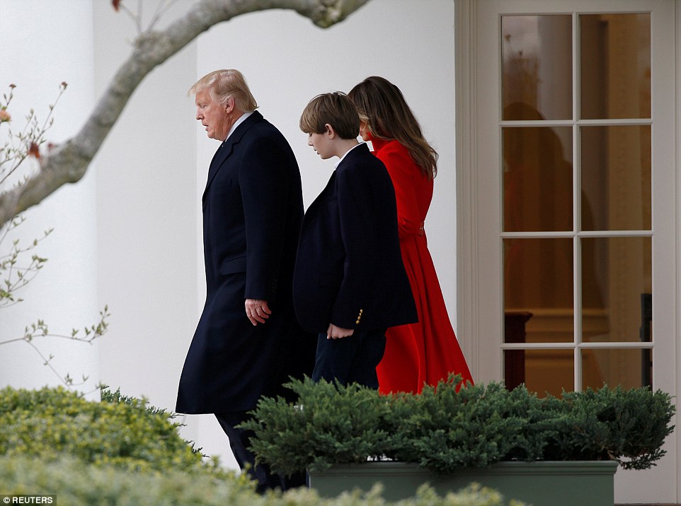 The Trumps walk with their son Barron to Marine One at the White House