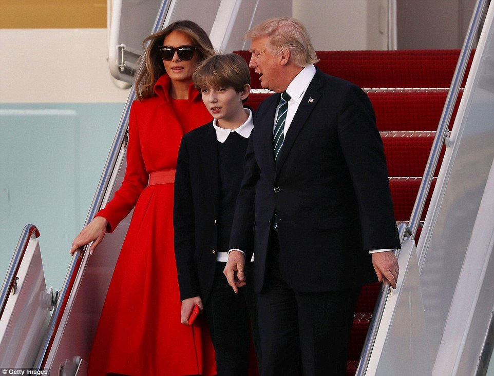 President Trump turns to speak to his 10-year-old son and his wife after they touched down