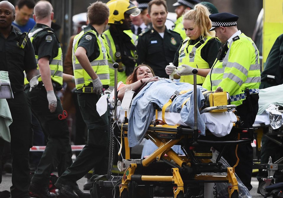 One woman is tended to by paramedics and cops after being injured on Westminster Bridge