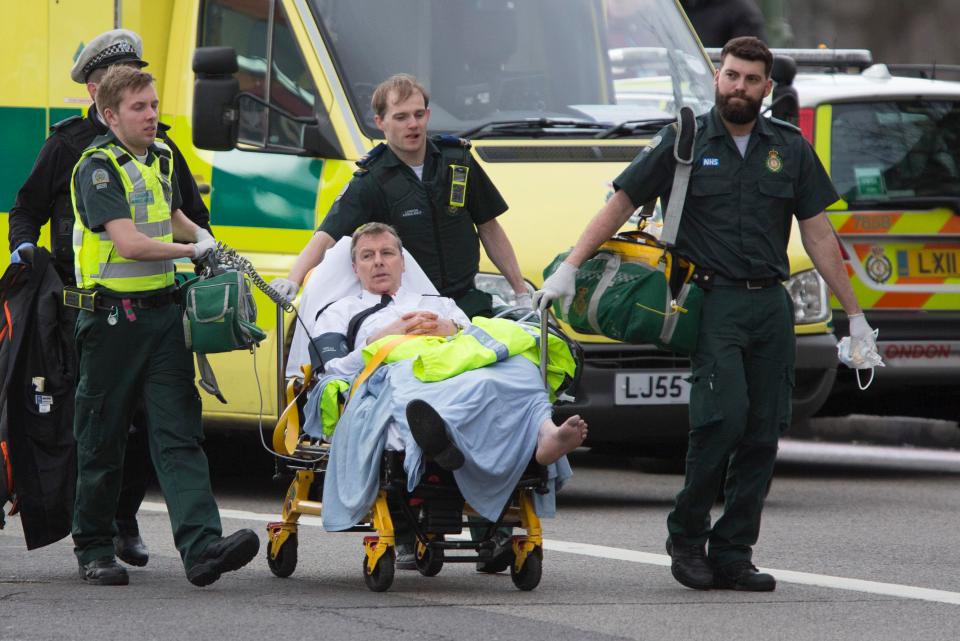 Paramedics treat one of the many injured in Westminster as it's confirmed two people have died 