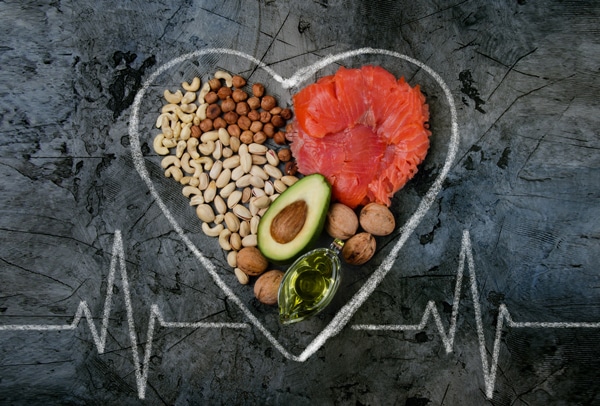 Nuts, Salmon, Olive Oil and Avocado Inside a Heart on a Chalk Board