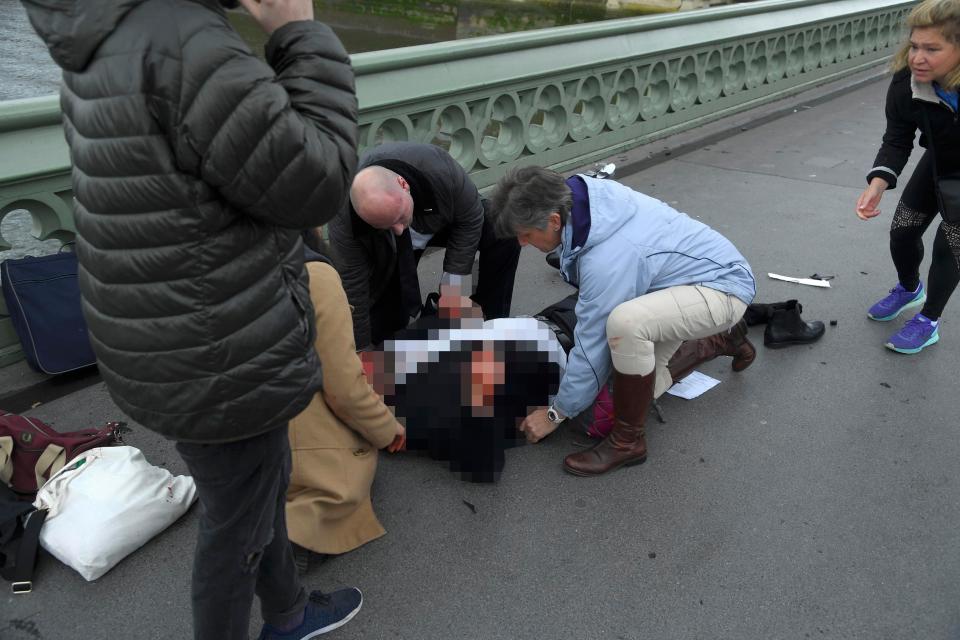 A man is treated on Westminster bridge by bystanders