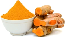 Turmeric Powder in a Bowl and a Pile of Turmeric Root
